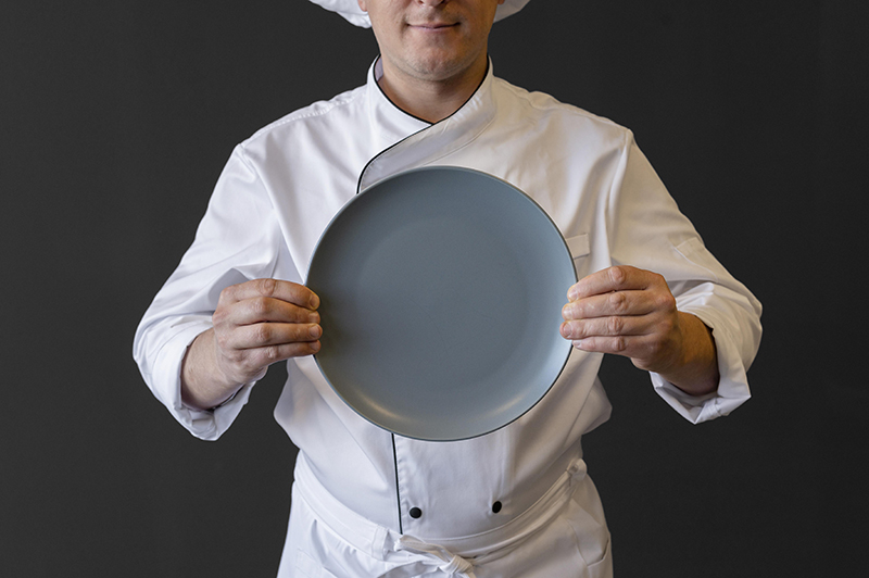 close-up-chef-holding-plate